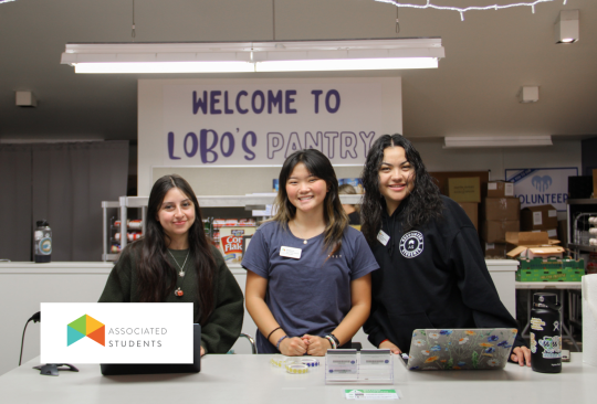 Three students working the Lobo's Pantry Check out Counter.